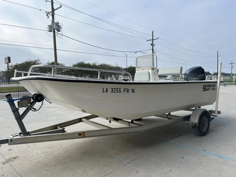 Slide: The Image of 2007 Carolina Skiff 198 DLX boat on trailer, parked outdoors. - 5