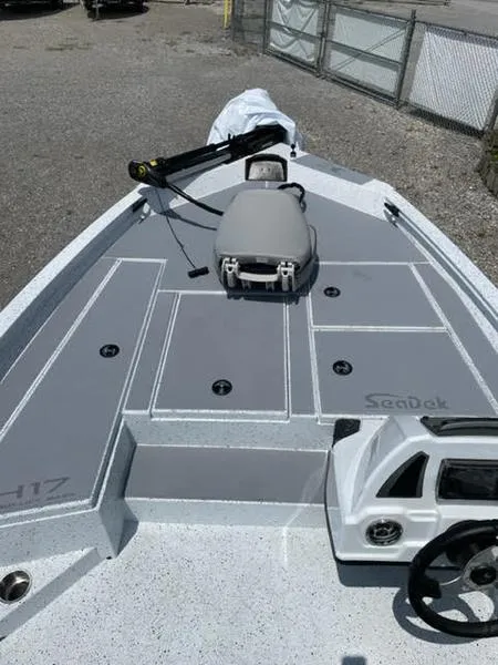 Slide: The Image of 2023 Xpress H17 boat deck with gray SeaDek flooring and steering console. - 3