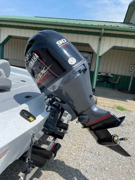 Slide: The Image of 2023 Xpress H17 boat with Yamaha 90 outboard motor, parked outdoors. - 5