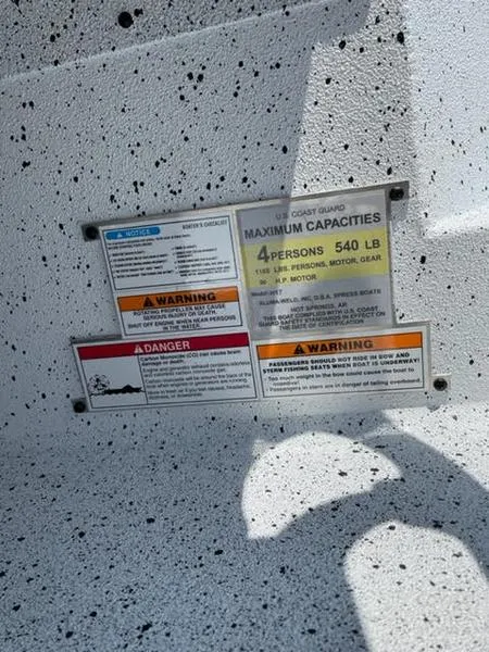 Slide: The Image of 2023 Xpress H17 boat capacity and safety warning labels, maximum 4 persons, 540 lbs. - 8