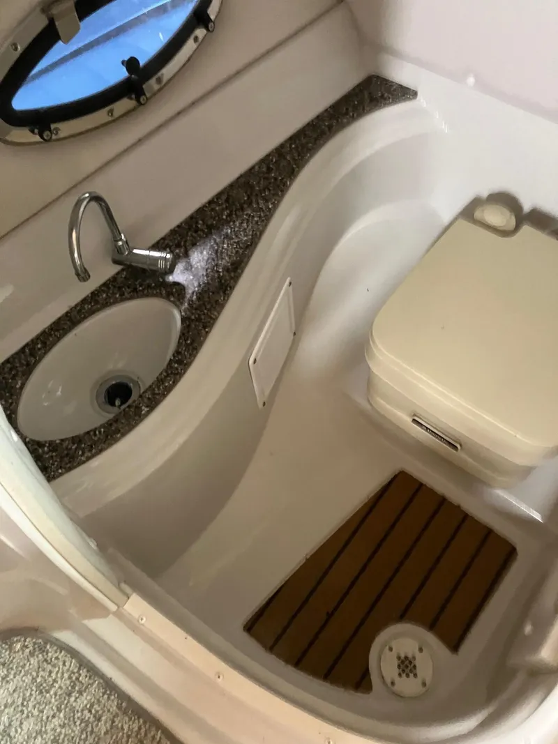 Slide: The Image of 2012 Crownline E2 Eclipse boat bathroom with sink and toilet. - 11