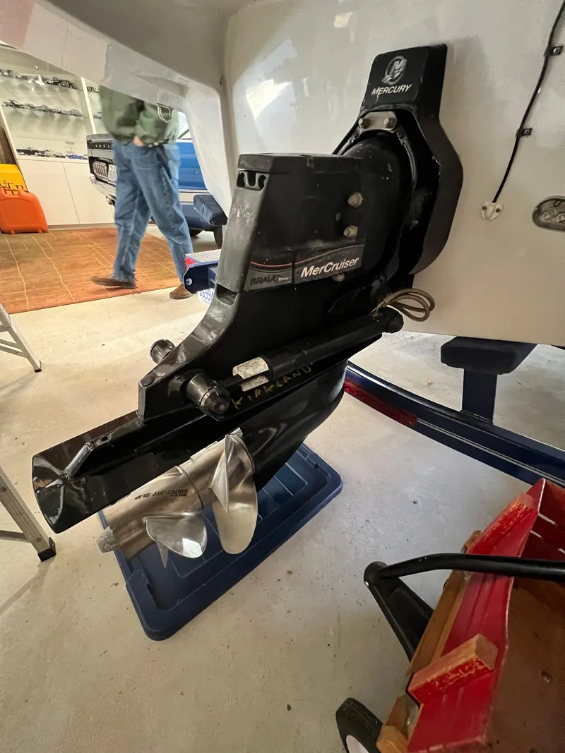 Slide: The Image of 2012 Crownline E2 Eclipse with MerCruiser outdrive in a garage setting. - 12