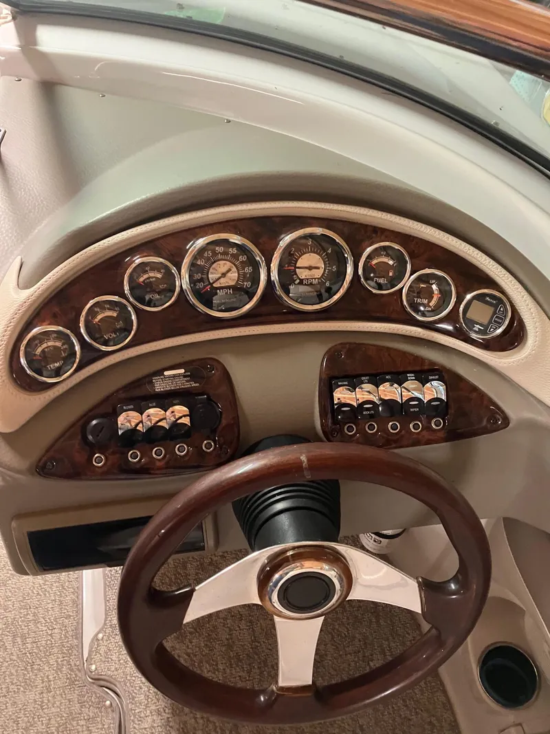 Slide: The Image of Dashboard of a 2012 Crownline E2 Eclipse boat with gauges and controls. - 9