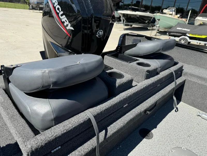 Slide: The Image of 2022 Lowe Fishing Machine 1675 WT boat interior with Mercury engine and cushioned seats. - 13