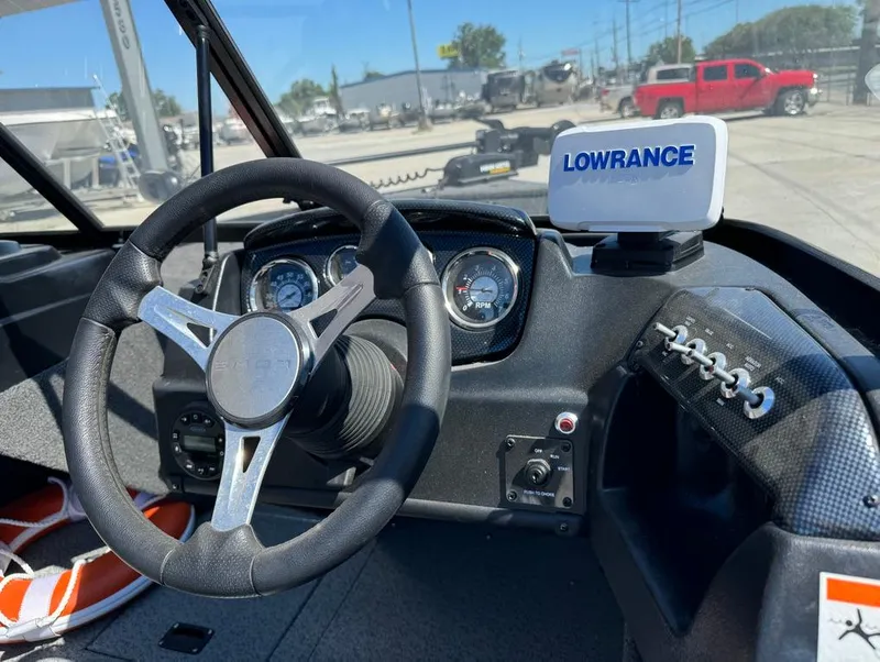 Slide: The Image of 2022 Lowe Fishing Machine 1675 WT dashboard with steering wheel and Lowrance device. - 15