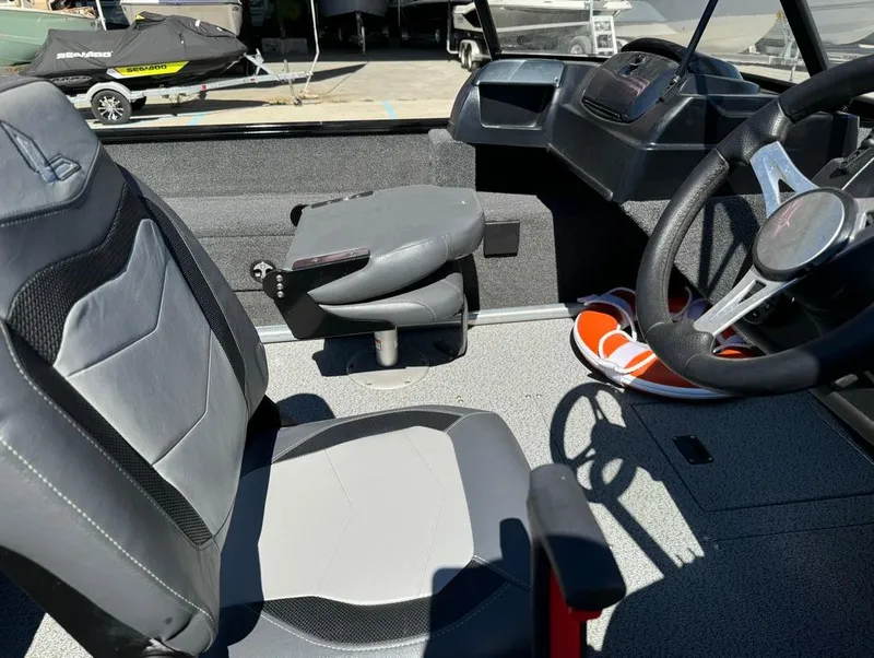 Slide: The Image of 2022 Lowe Fishing Machine 1675 WT interior with steering wheel and seating. - 16