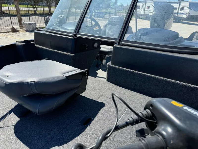 Slide: The Image of 2022 Lowe Fishing Machine 1675 WT interior with seating and control panel. - 18