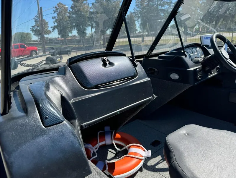 Slide: The Image of 2022 Lowe Fishing Machine 1675 WT interior with steering wheel and life ring. - 19
