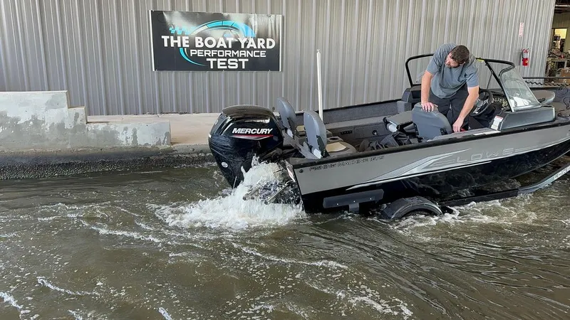 Slide: The Image of 2022 Lowe Fishing Machine 1675 WT undergoing performance test in water at boat yard. - 21
