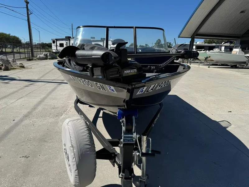 Slide: The Image of 2022 Lowe Fishing Machine 1675 WT on trailer, parked outdoors under clear blue sky. - 3