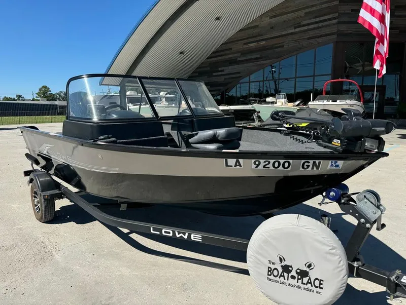 Slide: The Image of 2022 Lowe Fishing Machine 1675 WT boat on trailer, parked outdoors. - 4
