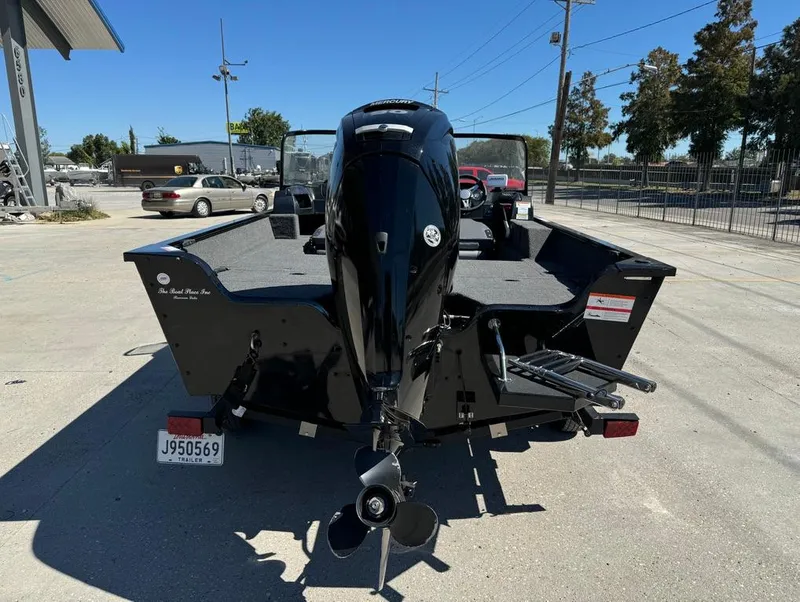 Slide: The Image of 2022 Lowe Fishing Machine 1675 WT boat, rear view, parked outdoors. - 7