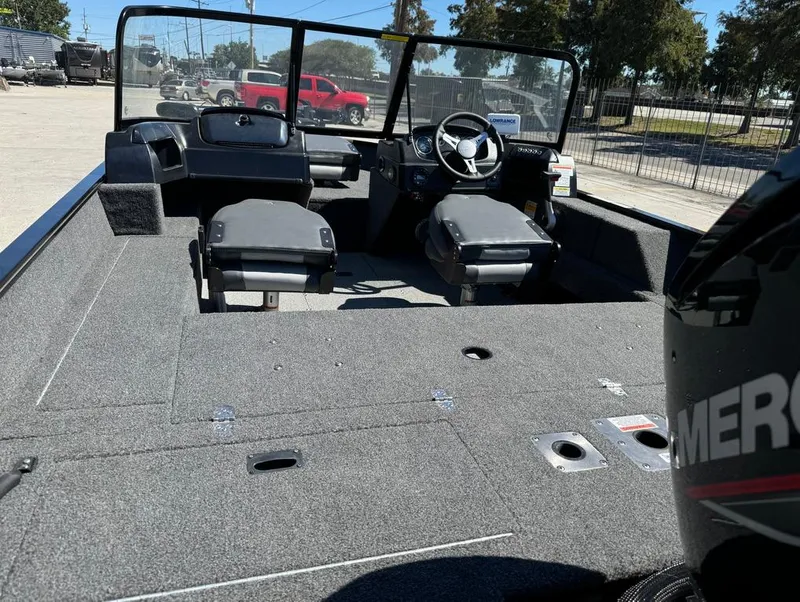 Slide: The Image of 2022 Lowe Fishing Machine 1675 WT boat interior with seating and steering console. - 9