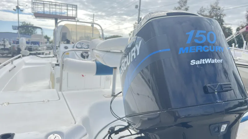 Slide: The Image of 2002 Fishmaster 1900 boat with Mercury 150 Saltwater engine, docked outdoors. - 9