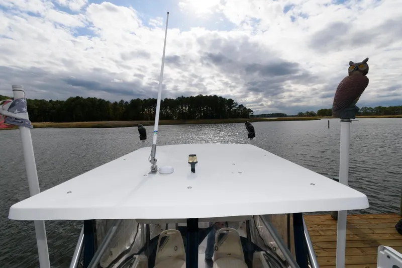 Slide: The Image of 1994 Grady-White Adventure 208 boat docked on a lake under cloudy skies. - 10