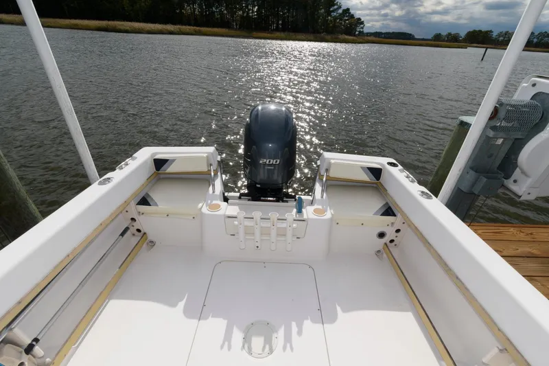 Slide: The Image of 1994 Grady-White Adventure 208 boat with outboard motor on a calm lake. - 2