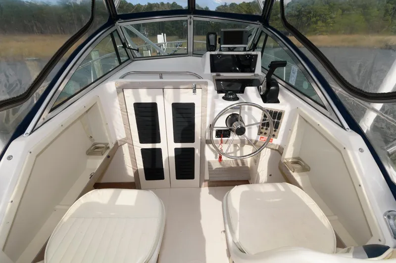 Slide: The Image of 1994 Grady-White Adventure 208 boat cockpit with steering wheel and seating. - 3