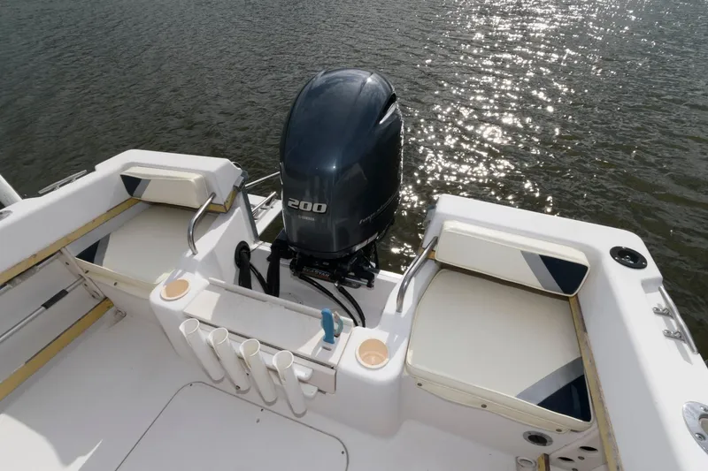 Slide: The Image of 1994 Grady-White Adventure 208 boat with outboard motor on calm water. - 5