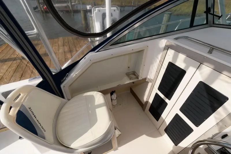Slide: The Image of 1994 Grady-White Adventure 208 boat interior with seating and storage compartments. - 9