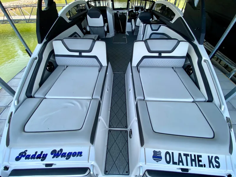 Slide: The Image of 2019 Yamaha Boats 275 SE interior with spacious seating, labeled "Paddy Wagen," docked in Olathe, KS. - 16
