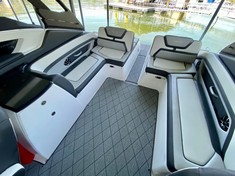 Slide: The Image of 2019 Yamaha Boats 275 SE interior with sleek seating and modern design on the water. - 19