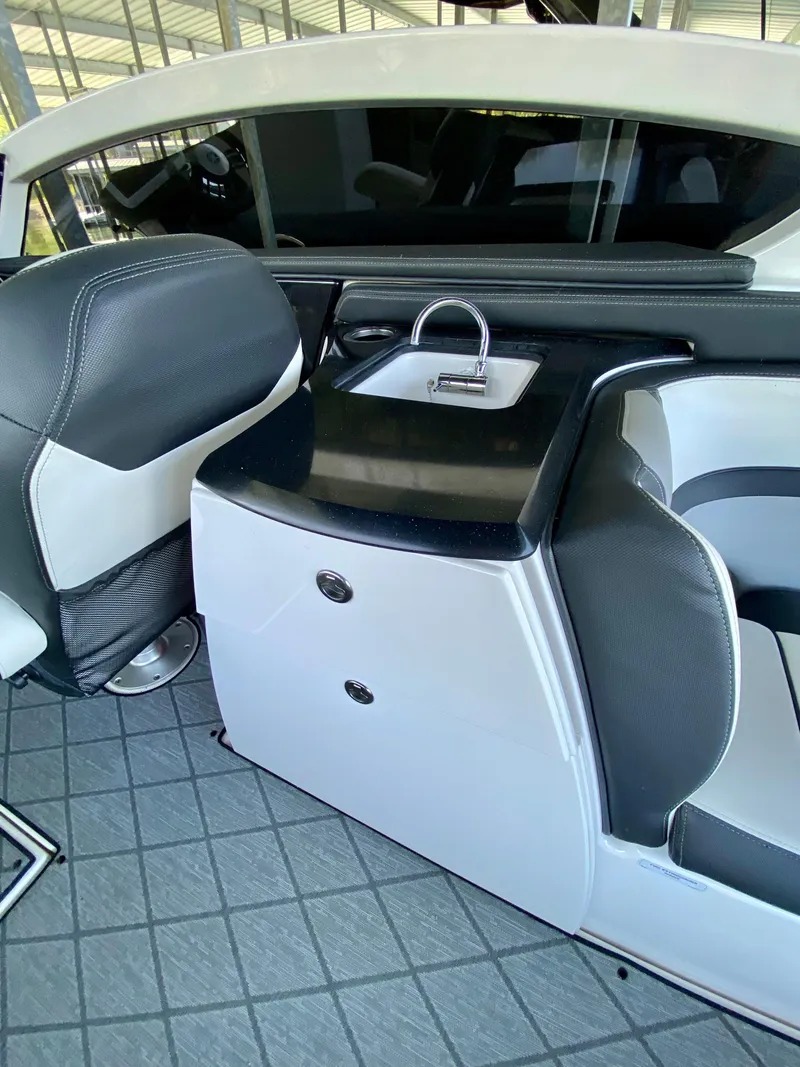 Slide: The Image of 2019 Yamaha Boats 275 SE interior with sleek seating and compact sink area. - 20