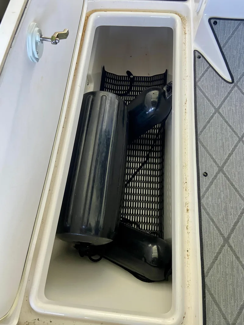 Slide: The Image of Storage compartment on a 2019 Yamaha Boats 275 SE with boating accessories. - 30