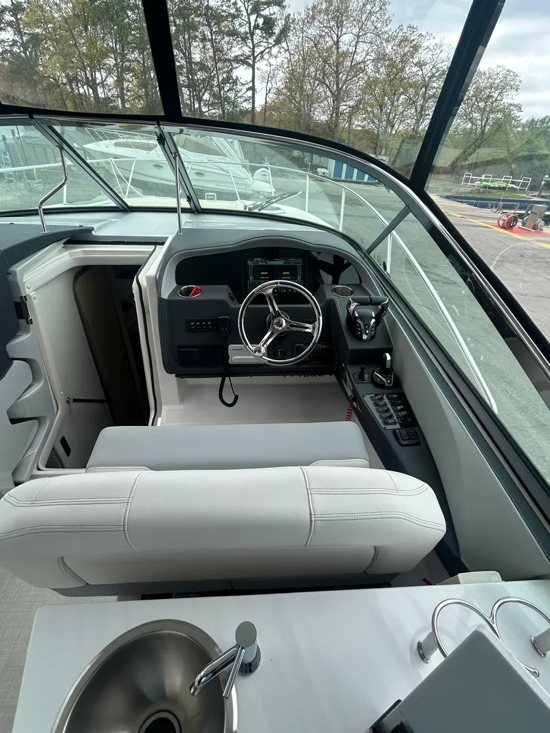 Slide: The Image of 2024 Regal 33 XO boat interior with steering wheel and sink, showcasing modern design. - 5