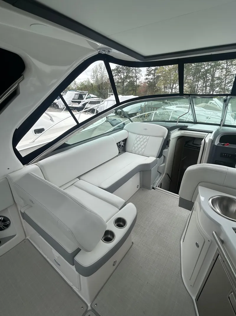 Slide: The Image of 2024 Regal 33 XO boat interior with white seating and modern amenities. - 6