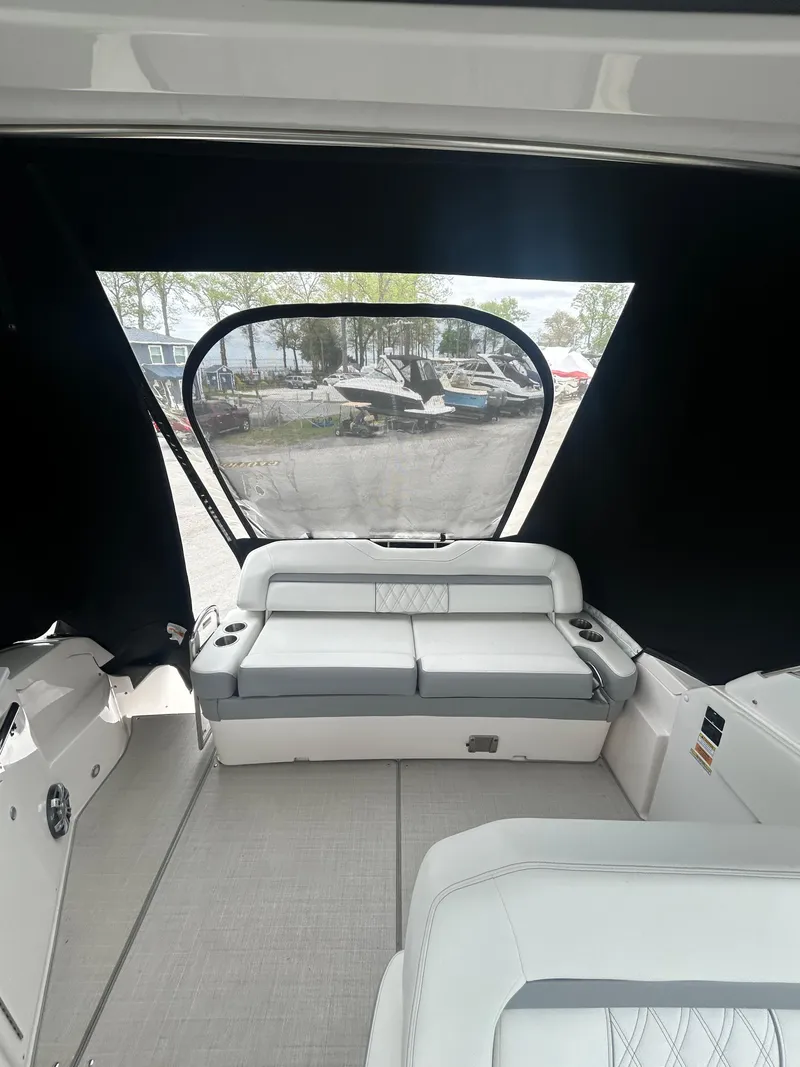 Slide: The Image of 2024 Regal 33 XO boat interior with seating and window view. - 7