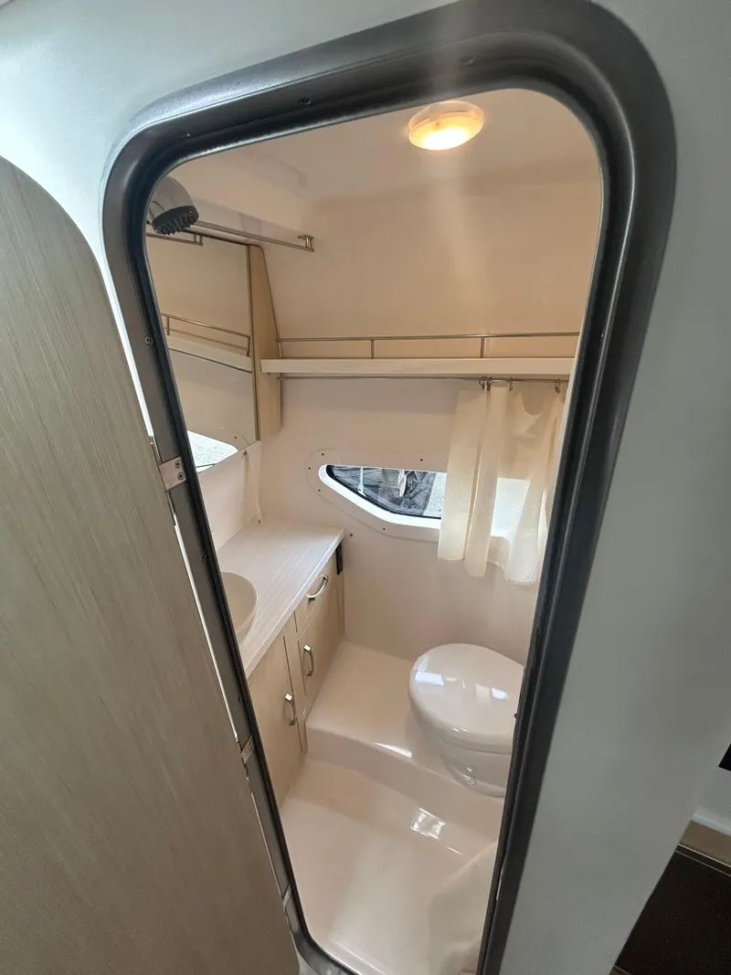 Slide: The Image of 2024 Regal 33 XO boat interior bathroom with modern fixtures and compact design. - 9