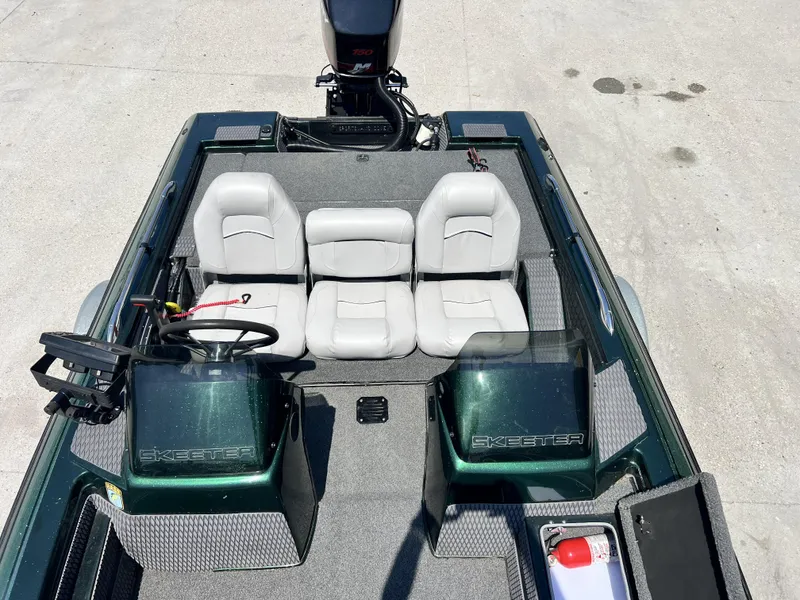 Slide: The Image of 1994 Skeeter 140 SLS boat interior with seating and steering console. - 12