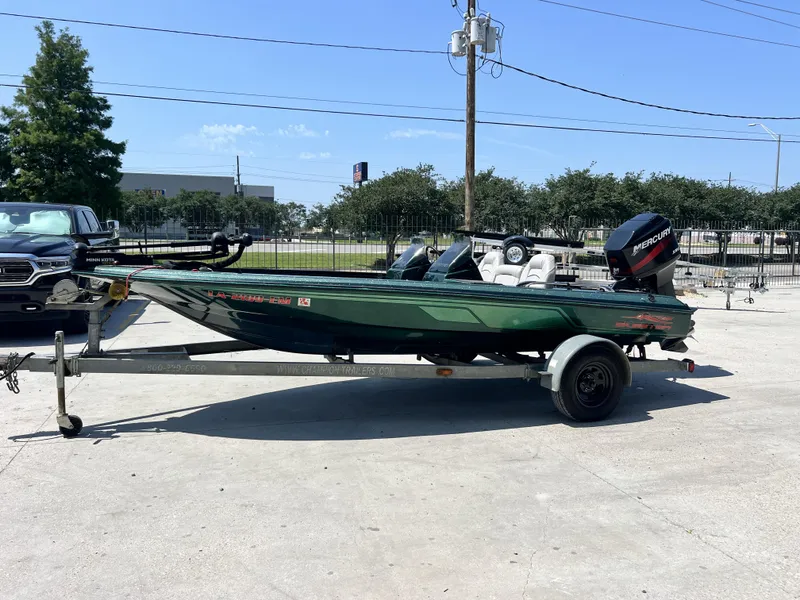 Slide: The Image of 1994 Skeeter 140 SLS boat on trailer, parked outdoors under clear sky. - 16
