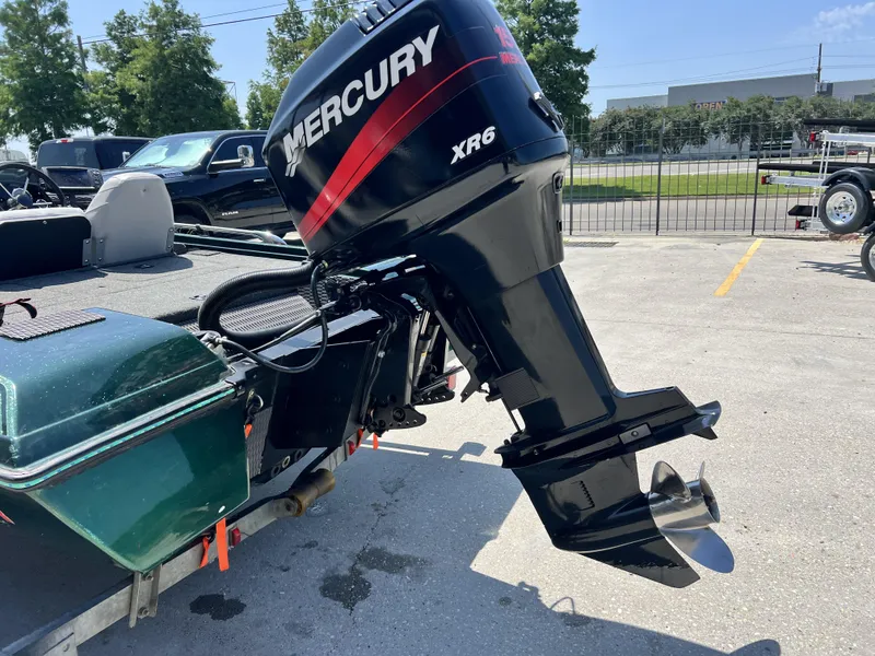 Slide: The Image of 1994 Skeeter 140 SLS boat with Mercury XR6 outboard motor in parking lot. - 17