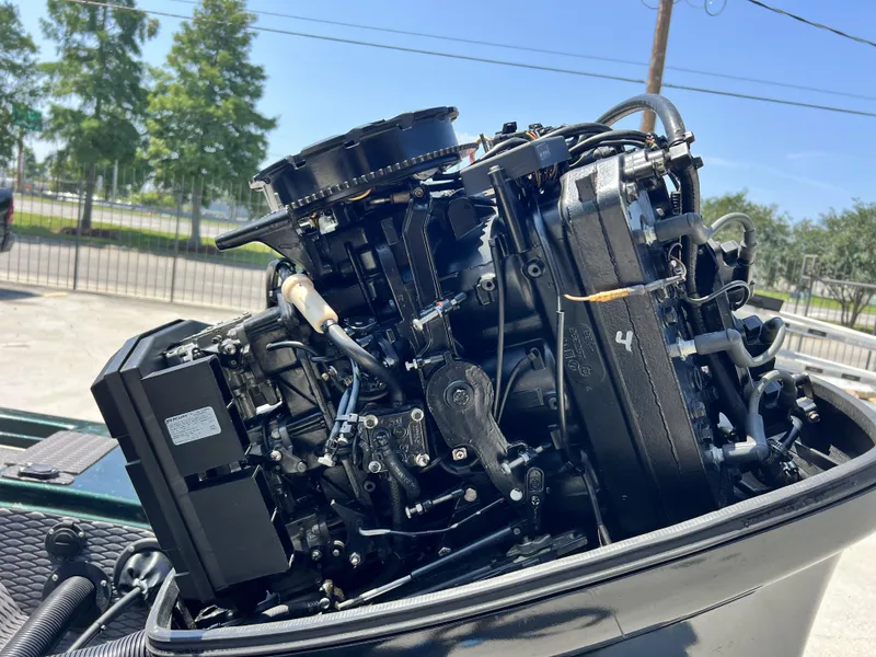 Slide: The Image of 1994 Skeeter 140 SLS boat engine, detailed view, outdoors, sunny day. - 19