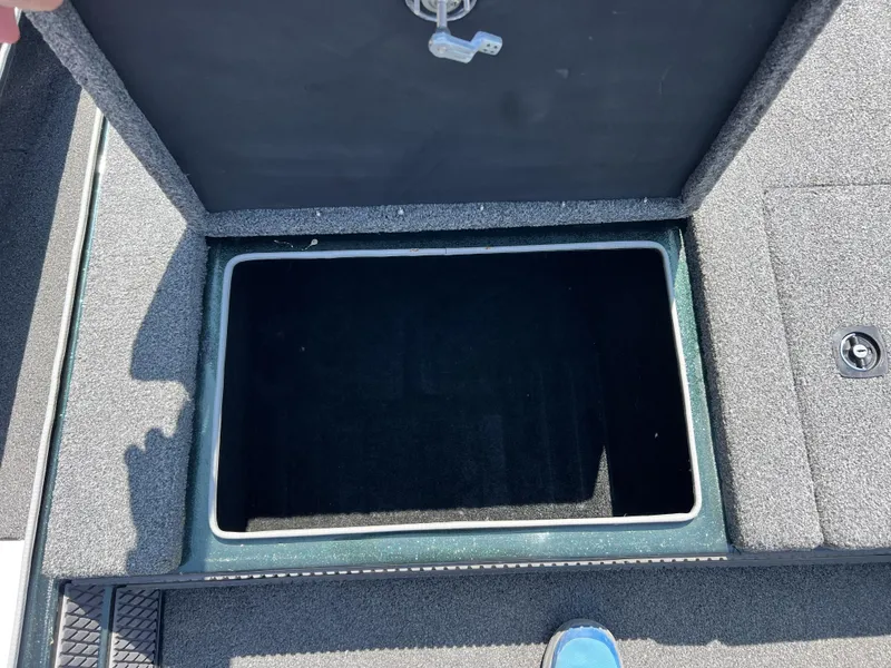 Slide: The Image of Open storage compartment on a 1994 Skeeter 140 SLS boat, showing interior space. - 23