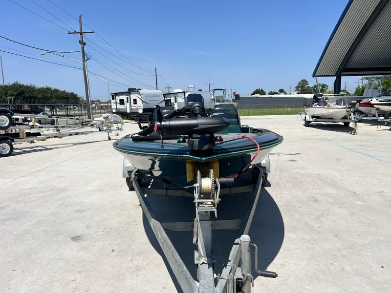 Slide: The Image of 1994 Skeeter 140 SLS boat on trailer in outdoor storage area. - 3