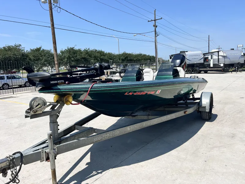 Slide: The Image of 1994 Skeeter 140 SLS boat on trailer, equipped with Minn Kota motor, parked outdoors. - 4