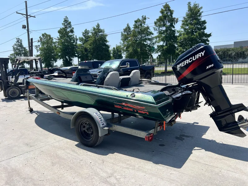 Slide: The Image of 1994 Skeeter 140 SLS boat with Mercury XR6 engine on trailer, parked outdoors. - 5