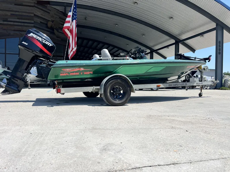 Slide: The Image of 1994 Skeeter 140 SLS boat on trailer with Mercury engine, parked outdoors. - 8