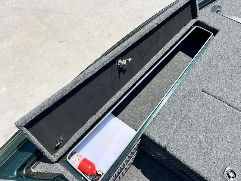 Slide: The Image of Open storage compartment on 1994 Skeeter 140 SLS boat with fire extinguisher. - 9