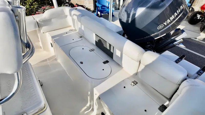 Slide: The Image of 2014 Tidewater 210 LXF boat interior with Yamaha engine, featuring white seating and storage compartments. - 11