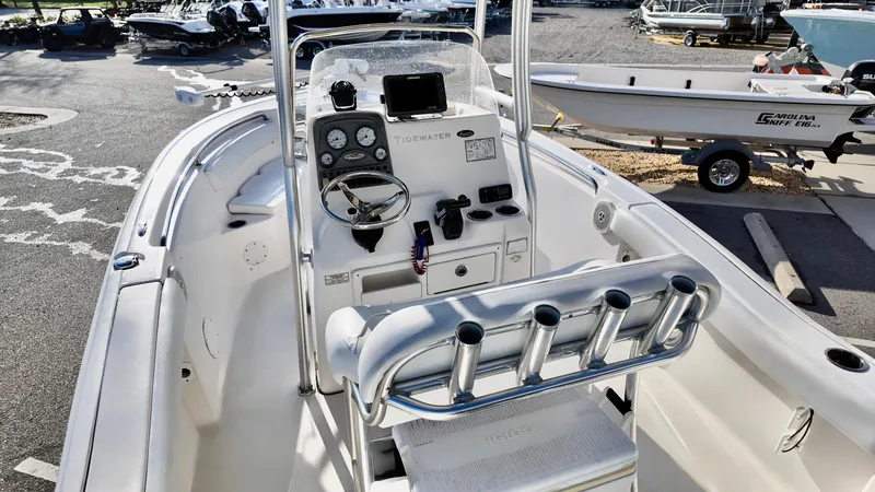 Slide: The Image of 2014 Tidewater 210 LXF boat interior with steering console and rod holders. - 5