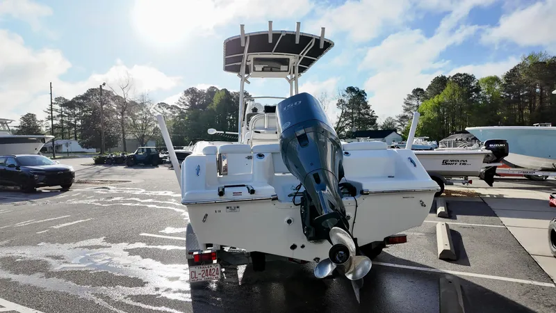 Slide: The Image of 2014 Tidewater 210 LXF boat with outboard motor in a sunny parking lot. - 6