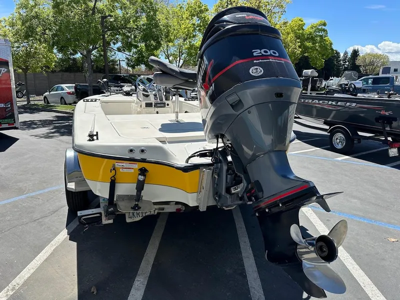 Slide: The Image of 2007 Ranger 191 Cayman boat with powerful outboard motor in a parking lot. - 11