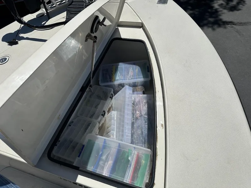 Slide: The Image of Storage compartment of 2007 Ranger 191 Cayman boat filled with organized tackle boxes. - 25