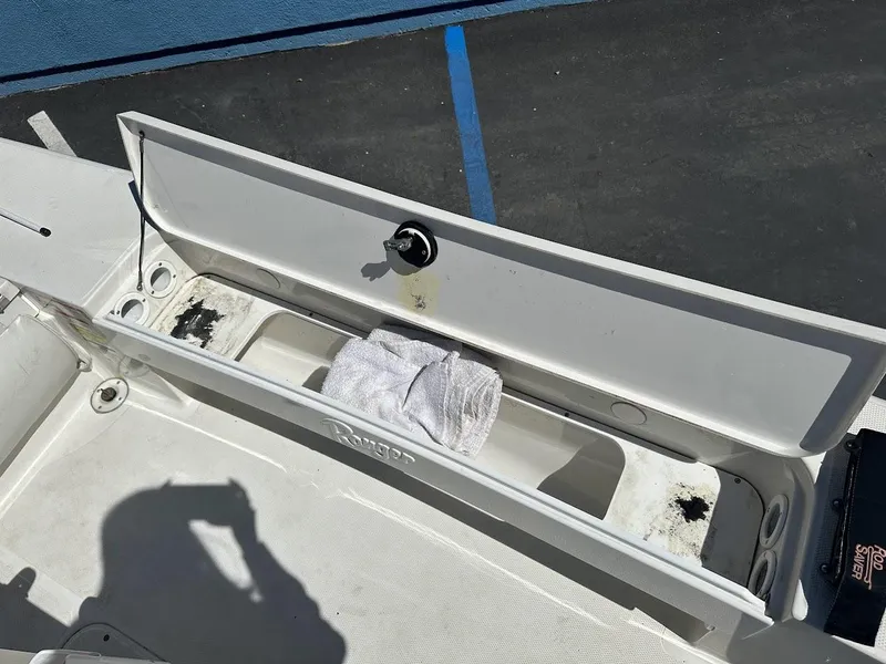 Slide: The Image of Open storage compartment on 2007 Ranger 191 Cayman boat with towel inside. - 26