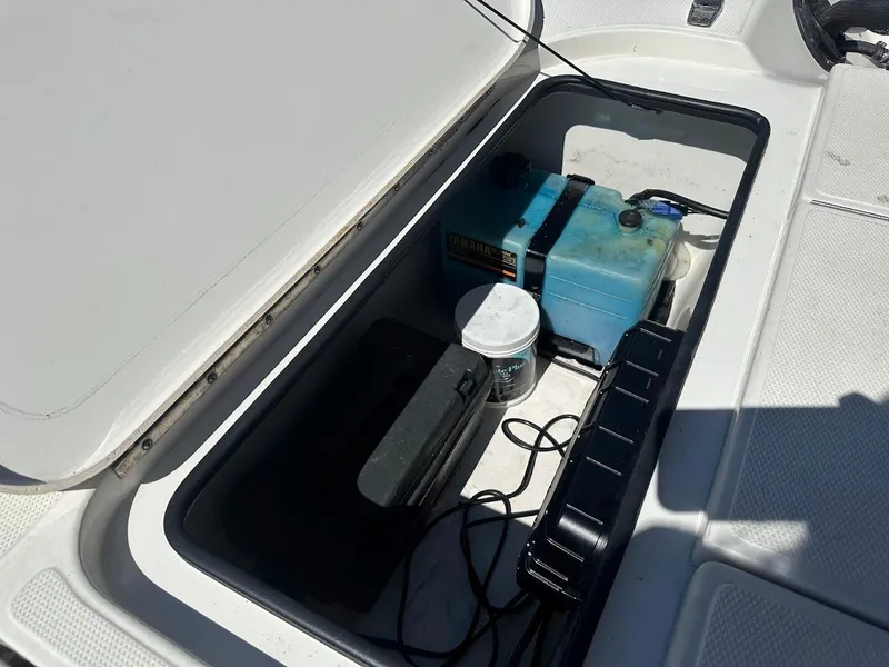 Slide: The Image of Open storage compartment in 2007 Ranger 191 Cayman boat, containing battery and equipment. - 30