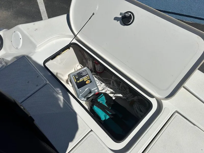 Slide: The Image of Open storage compartment on a 2007 Ranger 191 Cayman boat, containing ropes and supplies. - 31