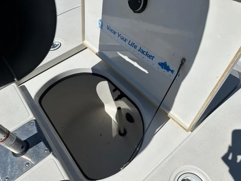 Slide: The Image of Open storage compartment on 2007 Ranger 191 Cayman boat with safety reminder. - 32